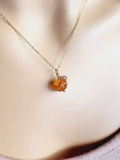 The Great Pumpkin has arrived! This adorable mini pumpkin necklace is wire wrapped with your choice of 14k gold filled, sterling silver or antique brass. The gemstone necklace is hand carved in the shape of a pumpkin. This dark orange carnelian gemstone necklace is available on your choice of chain length.►NOTE◄All pumpkins are randomly selected and will not be the exact one you see in the picture. Gemstones are natural and all will have some natural imperfections which makes your pumpkin gemsto Orange Gemstone Beads Round Jewelry, Orange Round Gemstone Bead Jewelry, Orange Round Gemstone Beads Jewelry, Orange Gemstone Necklaces As A Gift, Orange Agate Jewelry As A Gift, Wire Wrapped Amber Jewelry For Gift, Agate Jewelry With Lobster Clasp For Gift, Yellow Gold Agate Necklace As Gift, Dainty Amber Round Jewelry