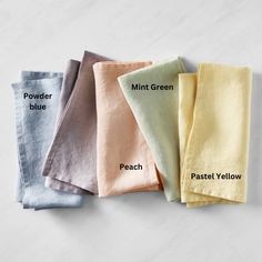 four different colored napkins with the names of each one on them, including powder blue, mint green, pastel yellow, and powder blue