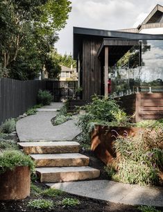 an outdoor garden with steps leading up to the house