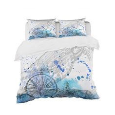 an image of a bed with blue and white paint splattered on it's sheets