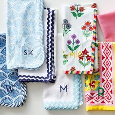 colorful towels and monogrammed napkins laid out on top of each other