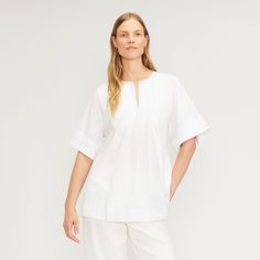 Caftan meets top. Taking all the relaxed vibes of a Caftan and shortening it into a tunic top, meet The Poplin Tunic. Made with crisp cotton poplin, it features a crew neck with front opening, front pleats, and easy Kimono sleeves. Cotton poplin is densely woven, making it both durable and breathable, also giving it a crisp, cool feel. Silk Tunic Top, Summer Tunic, Summer Tunics, Silk Tunic, Kimono Sleeves, Satin Maxi, Shortening, Kimono Sleeve, Tunic Shirt