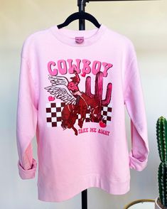 Cowboy Take Me Away Valentine's Day Graphic Sweatshirt features a super soft unisex body crewneck in pink with colorful western graphic art. Decorated at our headquarters in Tolar, Texas. Sizes Available: S-XXL Pink T-shirt For Fall Streetwear, Pink Graphic Print Top For Fall, Oversized Printed Pink Tops, Oversized Pink Printed Tops, Retro Pink Sweatshirt With Graphic Print, Retro Pink Graphic Print Sweatshirt, Casual Pink Sweatshirt With Graphic Print, Pink Long Sleeve Sweatshirt With Graphic Print, Pink Long Sleeve T-shirt With Graphic Print