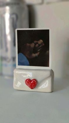 a small photo frame with a heart on it