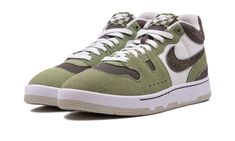 The Nike Mac Attack "Oil Green" is a colorway of the retro tennis shoe with an interesting design.  After being worn by tennis legend John McEnroe in the mid-1980s, the Nike Mac Attack returned as a lifestyle shoe in the 2020s, and was used in collaborations with the likes of Travis Scott and Social Status.  On the “Oil Green,” the shoe features Sail mesh on the sides, and Ironstone-colored mesh on the toe and forefoot.  Oil Green suede overlays can be found on the front of the shoe, while brown Nike Retro Skate Shoes With Gum Sole, Retro Nike Skate Shoes With Gum Sole, Retro Nike High-top Sneakers For Skateboarding, Retro Nike Skate Shoes With Rubber Waffle Outsoles, Retro Green High-top Skate Shoes, Retro Mid-top Skate Shoes With Gum Sole, Green Retro Skate Shoes With Rubber Waffle Outsoles, Retro Green Skate Shoes With Rubber Waffle Outsoles, Nike Retro High-top Sneakers