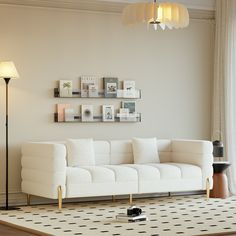 a living room with a white couch next to a lamp