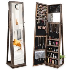 an open wooden jewelry cabinet next to a mirror