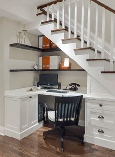 a home office under the stairs with desk and chair