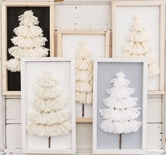 three white framed pictures with tasseled christmas trees