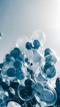 many clear balloons are floating in the air