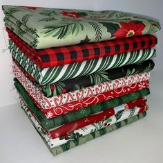 a stack of folded christmas fabric sitting on top of each other