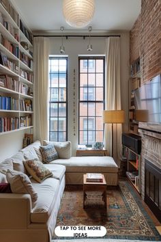 a living room filled with furniture and a fire place in front of a large window