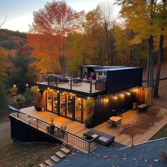 a house made out of shipping containers in the woods