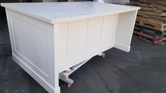 a white desk sitting on top of a pile of pallets