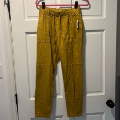 This Listing Is For One Pair Of 100% Cotton, Old Navy, Casual Pants, New With Tag. Nwt. These Are Very Cute And Have A Really Neat Woven Pattern And They Are Very Comfortable When You Try Them On. These Were Purchased And Never Worn Due To Size. This Is An Xs. I Would Say The Color Is Kind Of Like A Dark Mustard, Yellow, Almost A Brown. Please Note That There Is A Tiny Hole Up Near The Tag Where I Think Another Tag Must’ve Been. You Can See This In The Last Picture. Casual Mid-rise Yellow Pants, Casual Yellow Mid-rise Pants, Dark Mustard Yellow, Black Denim Overalls, Wide Leg Leggings, Athleisure Pants, Cotton Casual Pants, Leopard Print Leggings, Graphic Leggings