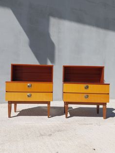 pair of mid century modern nightstands with drawers in yellow lacquer and wood