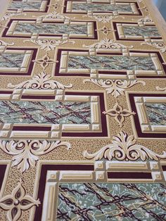 an intricately designed bed spread on top of a wooden table