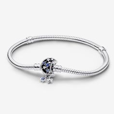 Bring a celestial touch to your style with the Pandora Moments Sparkling Moon Clasp Snake Chain Bracelet. With a clasp shaped like a crescent moon, this sterling silver snake chain bracelet has a "Dream big" engraving on the clasp's back. The intricate clasp features cut-out stars and circles set with six blue man-made crystals and five clear cubic zirconia, as well as microbeading and imprinted detailing. Two asymmetrical stars set with sparkling stones dangle from the clasp, adding a dash of m Adjustable Silver Celestial Charm Bracelet, Sterling Silver Celestial Bracelet, Celestial Charms Bracelet Jewelry, Metal Moon Charm Bracelet Jewelry, Celestial Silver Bracelet, Celestial Silver Charm Bracelet, Celestial Silver Metal Bracelets, Celestial Style Silver Metal Bracelets, Sterling Silver Celestial Bracelet With Moon Charm