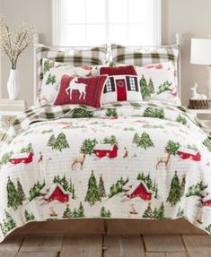 a bed with christmas themed comforter and pillows