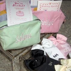 four personalized bags are sitting on the floor next to each other, one with a bow