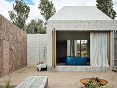 a house with a blue couch in the back yard