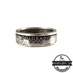 a coin ring with the word colorado engraved on it's front and bottom side