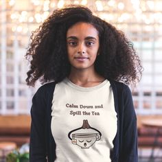 Embrace the humor with our "Calm Down and Spill the Tea" funny t shirt for women! Featuring a whimsical graphic of a tea cup in a serene pose, this novelty tee shirt is perfect for those who love a good gossip session. Whether you're chilling with friends or lounging at home, this ironic t shirt adds a touch of wit to your wardrobe. Available in multiple colors and sizes. Get your funny tee shirt for women today and stir up some laughter! This classic unisex jersey short sleeve tee fits like a w Relaxation Graphic Print Crew Neck Top, Graphic Print Crew Neck Tops For Relaxation, Crew Neck Top With Graphic Print For Relaxation, Spill The Tea, Funny Tee Shirts, Womens Jersey, Calm Down, The Tea, Halloween Women