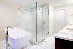 a bathroom with a tub, sink and shower stall in the middle of the room