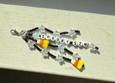 two halloween candy charms with words on them