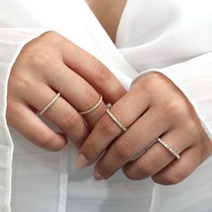 a woman's hand with two rings on it