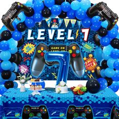 an inflatable video game console with balloons and streamers on the front for a birthday party