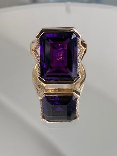 Ladies Womens Custom Luxury Handcrafted Rectangular Amethyst & Round Diamond Statement Ring 14 Karat Solid Yellow Gold Stamped Jewellery Ring Size: 6 and 1/4 US (can be adjusted to any finger size) Total Weight: 10.3 grams 24 round brilliant cut diamonds  1 Deep Purple Genuine Amethyst measuring approximately 18mm by 11mm Luxury Amethyst Ring Emerald Cut, Formal Rectangular Fine Jewelry Gemstones, Luxury Emerald Cut Amethyst Ring, Formal Amethyst Gemstones With Gemstone Accents, Formal Amethyst Gemstones With Accents, Luxury Purple Jewelry For Formal Occasions, Elegant Purple Gemstones With Accents, Purple Luxury Jewelry For Formal Occasion, Elegant Rectangular Amethyst Ring In Yellow Gold