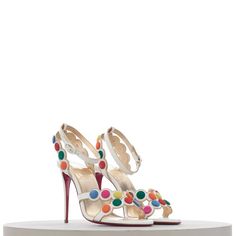 CHRISTIAN LOUBOUTIN SMARTISSIMA 100MM SANDALS IN WHITE LEATHER & MULTICOLOR DISKS Retailprice: 1095$ Description The Smartissima is a fun take on the strappy sandal. In a playful nod to the iconic Smarties sweets from Great Britain, the subtly iridescent white Kid Irisé upper features a circle pattern, mounted with multi-coloured disks that look just like these crisp-coated candies. This wacky upper perches over 100-mm slender stiletto heels, finished with a signature red sole for true Louboutin Iridescent White, Embellished Sandals, Fedex Express, Red Sole, Circle Pattern, A Circle, Strappy Sandals, Great Britain, White Leather