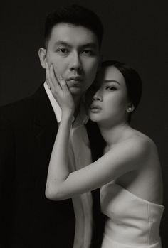 a man and woman posing for a black and white photo