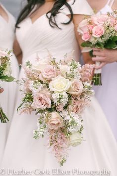 the bridesmaids are holding their bouquets together