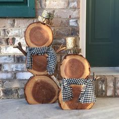 three pieces of wood stacked on top of each other in front of a green door