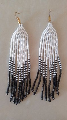 African beaded earrings, Handmade earrings, African jewelry, Maasai jewelry, Earrings for women,Gift for her, Tribal EarringsThese stunning earring are superbly crafted which will absolutely makes stand out in any occasion.Color - White and Black.3-5 days delivery via DHL ExpressThe shipping fee is for the first item only and additional necklaces or items ship for free.Wholesale available at a fair price,please contact me.For any clarification,please send me a convo or an e-mail.Thank you for vi Traditional Dangle Black Bead Jewelry, White Bohemian Beaded Earrings With Black Beads, Bohemian White Earrings With Black Beads, Traditional White Dangle Beads, Traditional Beaded Earrings With Round Beads, Traditional White Beaded Earrings With Ear Wire, White Beads With Ear Wire For Jewelry Making, White Teardrop Hoop Earrings With Dangling Beads, Traditional Beaded Dangle Hoop Earrings