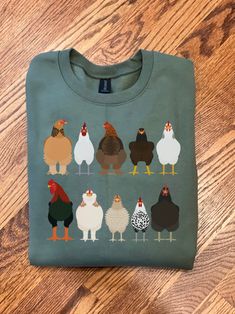 This Chicken Sweatshirt is great for Easter shirts or Women Chicken Shirt! This shirt makes a Funny Easter Shirt or Chicken Mom T-shirt! Our Farm Animal Tee Shirts are great for the Chicken lover or Chicken owner! Use as a Easter Tee or Chicken Tee for the Chicken mama in your life! { S H I R T / D E T A I L S } T-Shirts are 100% ringspun cotton and are UNISEX fit. Sweatshirts (no hood) & Hoodies (with hoods) are 50/50 cotton/polyester Both styles are soft & comfy. They are UNISEX size, fitting Chicken Sweatshirt, Farm Chickens, Chicken Mama, Funny Easter Shirt, Chicken Owner, Chicken Mom, Rooster Print, Easter Shirts, Cricut Shirts