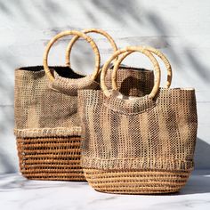 Gorgeously woven, this palm fiber handbag is truly one-of-a-kind. Made from locally sourced palm, this environmentally friendly handbag features fabric a cotton lining with small pockets within to keep your essentials organized! Palm fiber & cotton Lined handbag 1 interior zipper pocket 2 interior open pockets Small: 8" H x 10" L x 3.75" D (20.3 x 25.4 x 9.5 cm) Large: 10" H x 12" L x 3.5" D (25.4 x 30.5 x 8.8 cm) Handmade in & fairly-traded from Bangladesh Paw Print Jewelry, Spirit Clothing, Ribbon Jewelry, Fair Trade Jewelry, Printed Jewelry, Yoga Bag, Sleep And Loungewear, Flip Flop Shoes, Reusable Grocery Bags