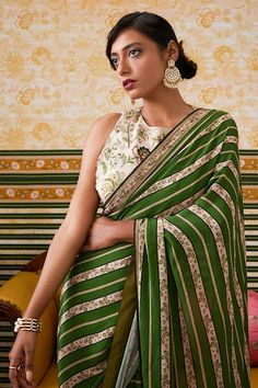 Green pre-draped saree in brocade silk base with all over ambrosia striped print and beads embellishments detail. Paired with a halter neck embellished blouse with fleur print. - Aza Fashions Draped Saree, Embellishment Details, Drape Saree, Green Saree, Embellished Blouse, Printed Sarees, Green Blouse, Striped Blouse, Sarees Online