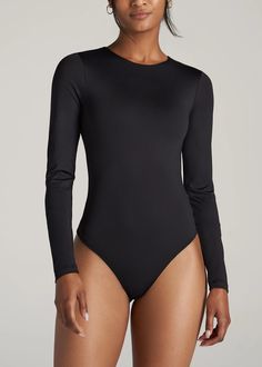 American Tall Long Sleeve Bodysuit. Made for ladies 5'9” to 6'6” with extra-long sleeves and a thong-cut bottom with an adjustable snap closure. Compressive Sleek Elastane Bodysuit, Long Sleeve Stretch Bodysuit With Smoothing Details, Long Sleeve Second-skin Smoothing Bodysuit, Sleek Long Sleeve Bodysuit With Minimal Stretch, Sleek Long Sleeve High Stretch Leotard, Sleek Long Sleeve Leotard, Sleek Micro-elastic Elastane Bodysuit, Sleek Long Sleeve Second-skin Leotard, Solid Long Sleeve Leotard With Thumbholes