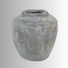 a large gray vase sitting on top of a table