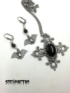 "This fantastic silver plated filigree cross necklace features a Swarovski black jet crystal and is part of our new Dark Gothic range, and is a step away from our previous steampunk work.The set comes complete with our spooky silver plated vampire bat earrings! There are numerous Gothic designers out there, and various marketplaces to purchase Gothic jewellery, but i am sure you will like what we are doing here Growing up in the 80's i lived through the \"goth\" movement, many a lost weekend was Black Cross Jewelry For Halloween, Gothic Cross Pendant Jewelry For Halloween, Gothic Cross Jewelry For Gifts, Gothic Cross Jewelry As Gift, Gothic Cross Jewelry Gift, Silver Cross Jewelry For Halloween, Black Cross Pendant Jewelry For Halloween, Silver Vampire Style Metal Jewelry, Gothic Nickel-free Cross Jewelry