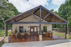 a covered patio area with tables and chairs