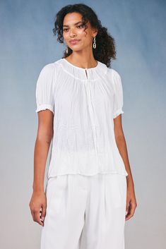 With its flowy shape and crinkle texture, this short-sleeve pleated top is just the right piece for creating effortlessly chic looks. It's softly textured and floats elegantly on the figure, drawn in by delicate ruffle trim. •Relaxed fit •Pullover styling •Cuffs Item number 2430190 100% Polyester Textured Short Sleeve Blouse For Summer, Textured Short Sleeve Summer Blouse, Elegant Summer Top With Crinkle Texture, Elegant Summer Tops With Crinkle Texture, Chic Textured Short Sleeve Tops, Chic Short Sleeve Textured Tops, Chic Crinkle Texture Blouse For Daywear, Chic White Blouse With Crinkle Texture, White Crinkle Texture Blouse