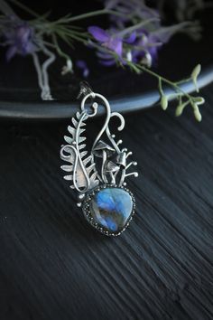 ITEM DESCRIPTION: The size H 5 cm x W 3 cm (1 2/3 x 1 inch). Weight - 10 g. You can buy it with a silver chain or without it. This is the unique handmade necklace - the part of wild Ukrainian woodland with amazing fern and cutest mushrooms. I made this botanical pendant of sterling and fine silver and natural labradorite. The stone has a beautiful golden glow. It's perfect if you like elegant plant jewelry and nature. PLEASE BE AWARE! I made it from natural stone. There are no two identical natu Nature-inspired Jewelry With Large Pendant For Healing, Nature-inspired Healing Jewelry With Large Pendant, Unique Labradorite Pendant Necklace, Nature-inspired Sterling Silver Wire Wrapped Necklaces, Handmade Silver Whimsical Jewelry, Nature-inspired Wire Wrapped Sterling Silver Necklaces, Nature-inspired Sterling Silver Wire Wrapped Jewelry, Whimsical Handmade Silver Jewelry, Nature-inspired Silver Labradorite Necklace