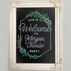 this is it welcome to morgan charles party sign on a chalkboard with greenery