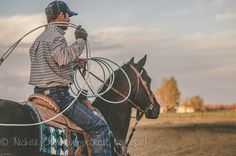 a man riding on the back of a brown horse