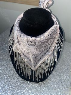 Our rhinestone bandanas are the perfect accessory to wear with any rhinestone cowgirl hat or alone by themselves! Wear them with denim dresses, sequin outfits, flannel shirts, jumpsuits and more! If you are looking to dress your outfit up or take it to the next level these are for you! Each bandana is hand made and features nearly 2ft of rhinestone chain. Bandanas will ship within 2 business days unless ordered alongside a rhinestone cowgirl hat. If ordered with a hat, we will ship both items to Diamond Shirt Outfits, Bling Cowgirl Costume, Rhinestone Cowgirl Outfits Western Wear, Rhinestone Cowboy Hat Outfit, Western Style Jewelry, Adjustable Bandana For Summer Parties, Adjustable Summer Party Bandana, Denim Rhinestone Outfit, Rhinestone Cowgirl Costume