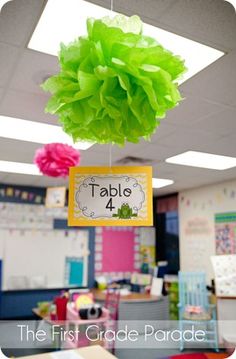 the first grade parade is decorated with tissue pom - poms and paper flowers